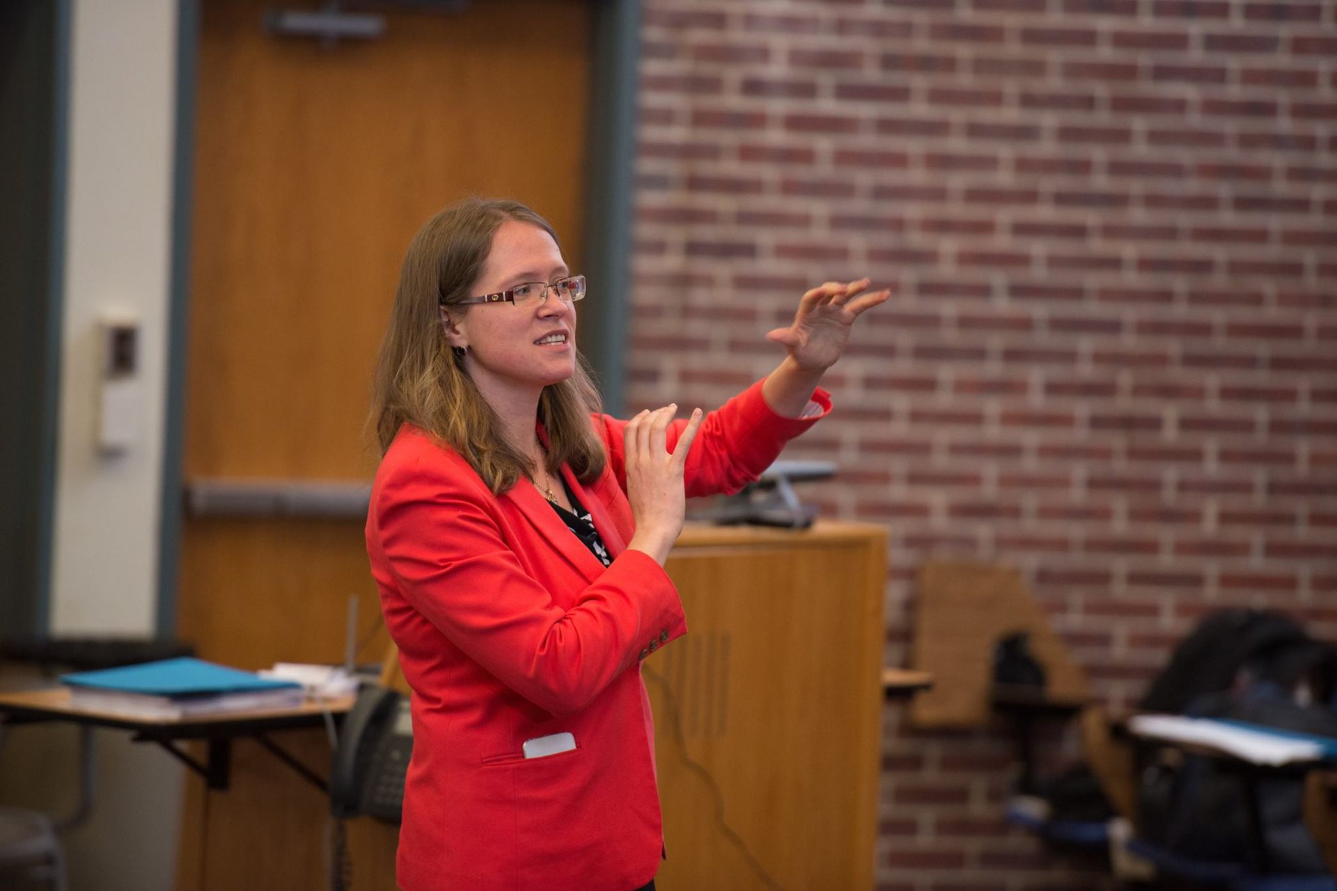 Tatiana teaching in a red blazer